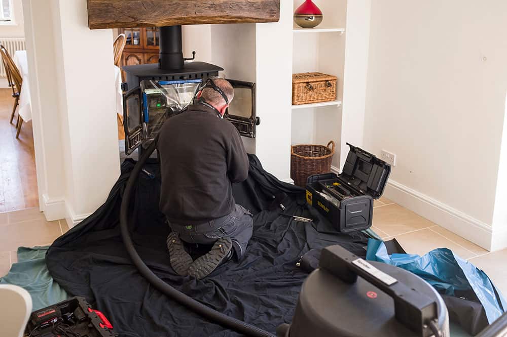 Picture showing a chimney sweep, sweeping a chimney in Haringey